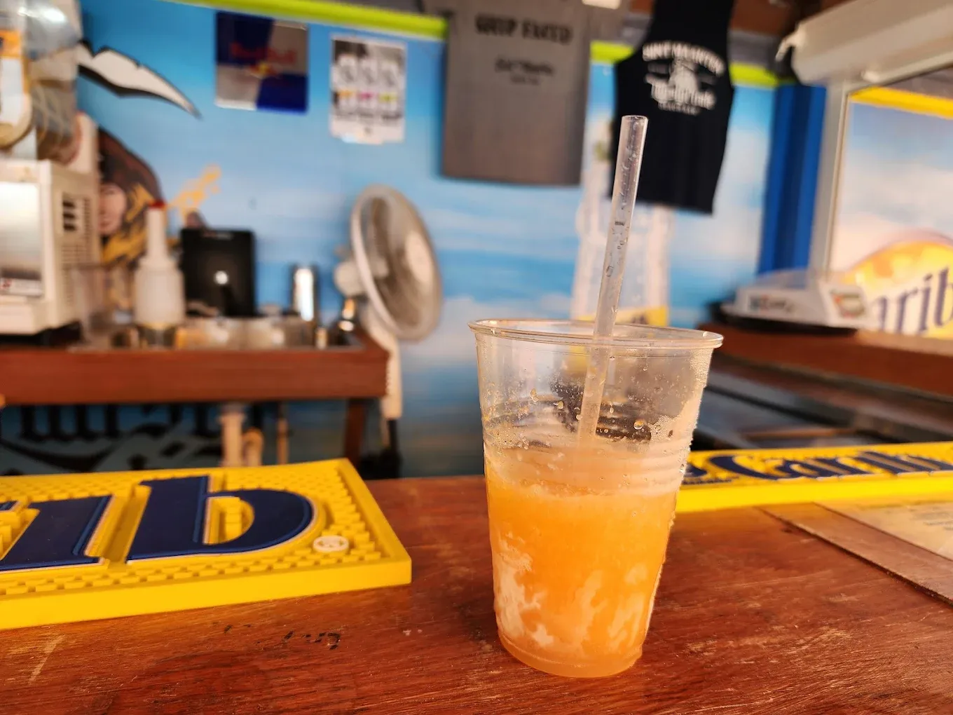 Frozen rum punch in a cup on the bar top at Thirsty Pirate Beach Bar, Sint Maarten