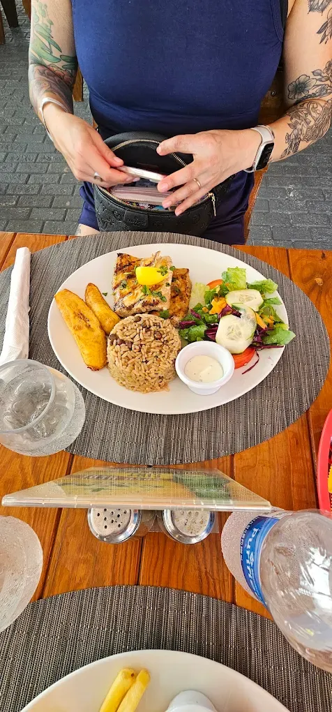 Grilled mahi mahi plate with seasoned rice, fried plantains and fresh salad at Thirsty Pirate in Philipsburg